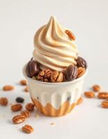 Delicious soft serve ice cream topped with nuts and chocolate in a decorative cup photo