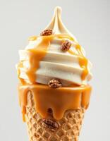 Creamy caramel swirl ice cream topped with crunchy nuts in a waffle cone served in a bright setting photo