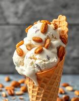 Delicious ice cream cone topped with almonds served against a textured gray background photo