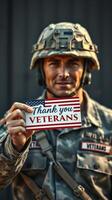 Soldier holding a thank you card for veterans in military uniform during daylight at a military base photo