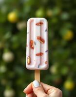 Delicious frozen treat featuring nuts and goji berries enjoyed in a sunny garden setting photo