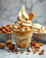 Creamy ice cream dessert with nuts and caramel served in a glass on a marble countertop photo