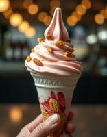 Handmade strawberry swirl ice cream cone topped with crunchy granola in a cozy cafe setting photo