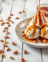Delicious dessert featuring scoops of ice cream topped with rich caramel sauce and scattered nuts on a rustic wooden table photo