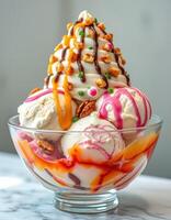 Delicious ice cream sundae topped with nuts, chocolate sauce, and colorful sprinkles served in a clear glass bowl photo