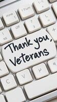 Thoughtful message of gratitude displayed on a computer keyboard honoring veterans photo