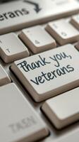 Thank you veterans message written on a keyboard during a commemorative event in a quiet room photo