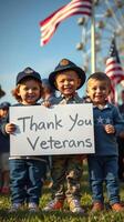 Children holding a sign to honor veterans during a community event in the park on a sunny day photo