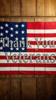 Thank you veterans sign displayed in front of an American flag on a wooden wall photo