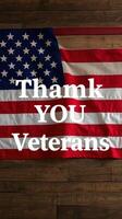 Thank you veterans message displayed on an American flag in a rustic setting photo