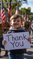 Young boy expresses gratitude during a patriotic parade with flags and service members in background on a sunny day photo