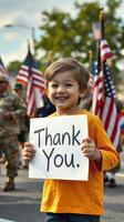 Young child expresses gratitude with sign during a patriotic parade honoring veterans in a festive downtown setting photo