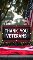 Sign expressing gratitude to veterans during a memorial event in a park on a sunny day photo