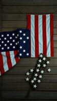 Stars and stripes decor displaying American flags and a star accent on wooden background for patriotic celebrations photo