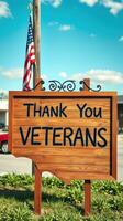 Sign expressing gratitude to veterans in a community setting during daytime photo