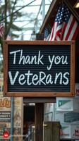 Community appreciation sign honoring veterans displayed at a local event on a sunny day photo