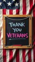 Thank you veterans message displayed on a chalkboard against a backdrop of a flag photo