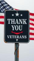 Veterans Day celebration with sign of appreciation and American flag waving in the background photo