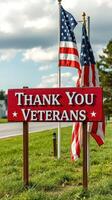 Sign expressing gratitude for veterans in a public area with flags on a sunny day photo