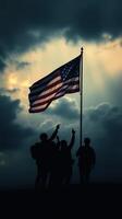 Soldiers celebrate the American flag against a dramatic, cloudy sky during a commemorative event at dusk photo