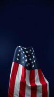 Colorful American flag draped against a dark background showcasing patriotism and unity photo