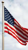American flag waving proudly against a cloudy sky, symbolizing national pride and unity in an outdoor setting photo
