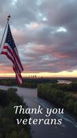 Sunset view overlooking river and city skyline with American flag honoring veterans photo