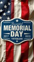 Memorial Day tribute sign displayed against a backdrop of an American flag photo
