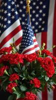 Red carnations and American flags create a patriotic display for a national celebration or event photo