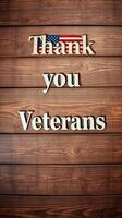 Thank you veterans displayed on wooden background with American flag detail photo