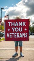 Child holding thank you veterans sign during community event in bright afternoon light photo