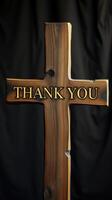Wooden cross with an engraved message expressing gratitude against a dark background photo