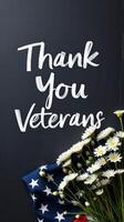 Thank you veterans message with patriotic flag and white daisy flowers arranged creatively photo