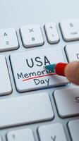 Hand writing on a keyboard key to commemorate Memorial Day in the USA photo