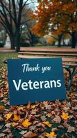 Community honors veterans with a heartfelt thank you sign in a park during autumn photo