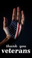 Hand with painted American flag shows gratitude for veterans during a commemorative event photo
