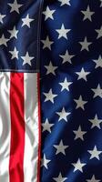 American flag with bold red stripes and intricate patterns of white stars on a blue field displayed proudly in daylight photo