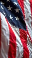Waving American flag displaying vibrant colors during a sunny day in a public space photo