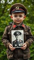 Young boy dressed in military uniform holds vintage photo honoring historical soldier outdoors