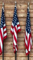 Three American flags displayed proudly against a rustic wooden wall at an outdoor gathering celebrating patriotism and unity photo
