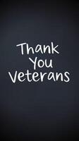 Celebration of veterans with heartfelt message displayed on chalkboard during community event photo