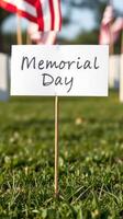Honor and remembrance on Memorial Day with flags and dedication markers in a green park setting photo