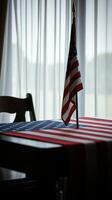 Table decorated with American flag under soft window light during a calm morning setting photo
