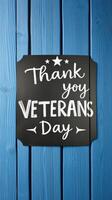 Creative display of a thank you message celebrating Veterans Day on a blue wooden background photo