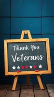 Sign expressing gratitude to veterans displayed on an easel against a blue wall during a commemorative event photo