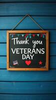 Thank you Veterans Day sign with patriotic decorations displayed on a blue wooden background photo