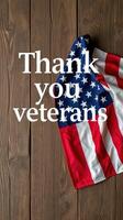 Celebrating veterans with an American flag display and heartfelt gratitude on a wooden surface photo