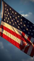 Waving American flag against blue sky with clouds during golden hour photo