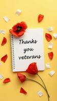 Veterans Day tribute with a heartfelt message on a notepad surrounded by flowers and petals photo