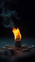 Small flame ignites from a metal holder showcasing the beauty of fire in a dark environment photo